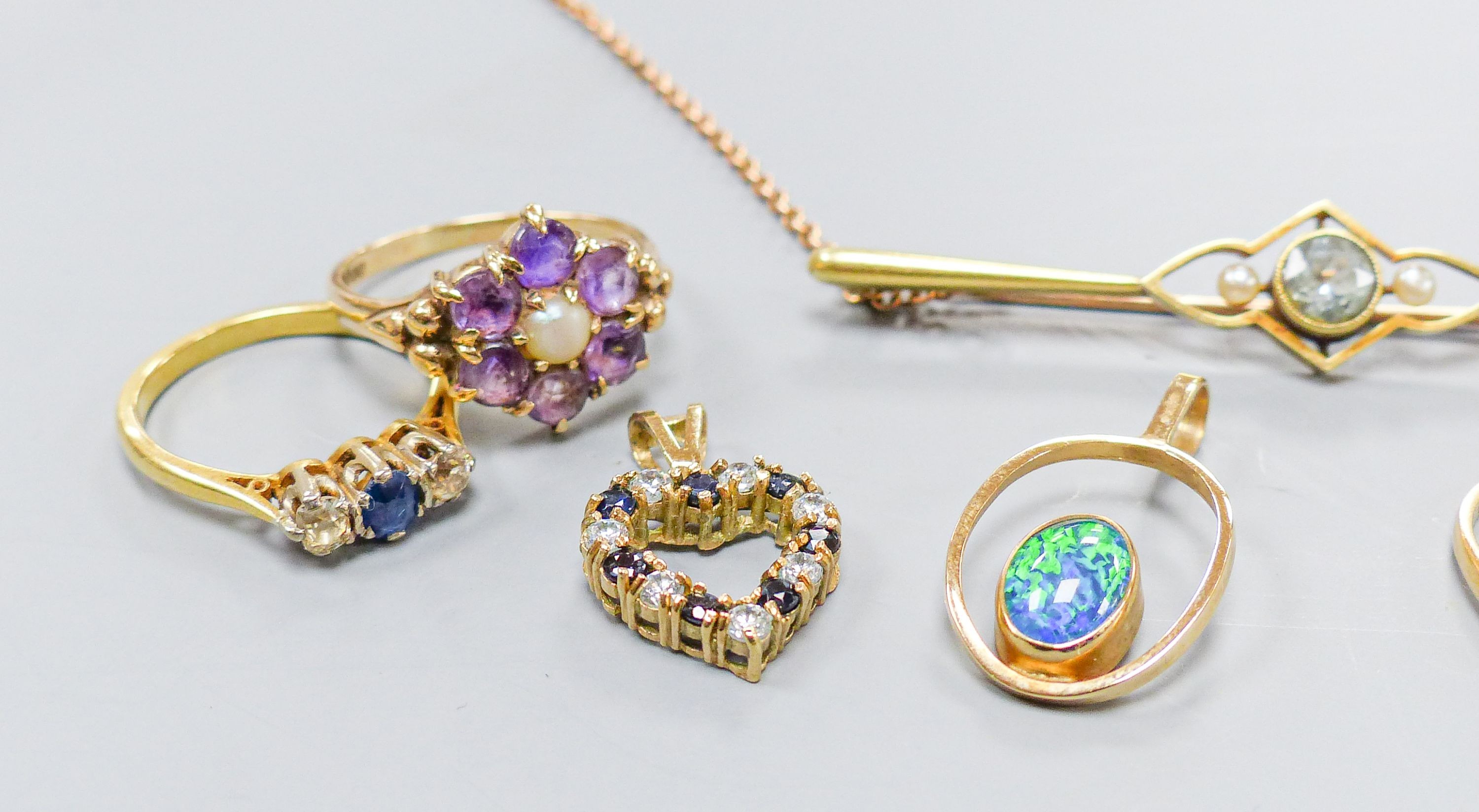 Three 18ct gold and gem set rings including two five stone half hoop(one stone missing) and a sapphire and diamond three stone, gross weight 7.3 grams, four 9ct and gem set rings and a 9ct pendant, gross 11.8 grams, a 15